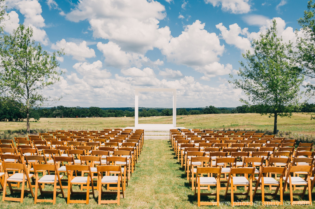 chairs leading up to a wedding alter overlooking the sky