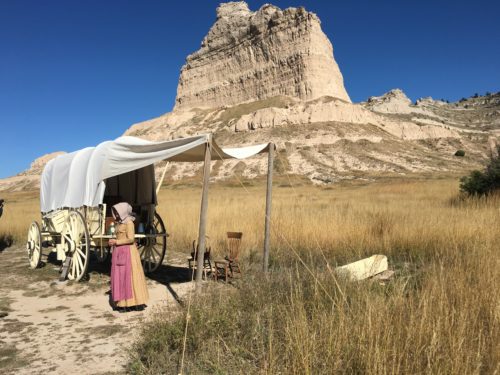 Park Ranger Lesley Gaunt regales visitors to Scotts Bluff National Monument by dressing as a pioneer and relating information about traveling by wagon train. Photo by Leah Nyfeler
