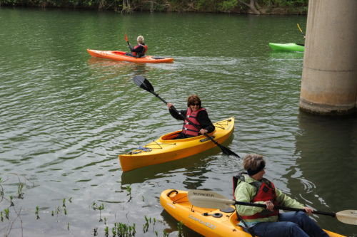 A group of women kayaking during a Wild Woman Weejend