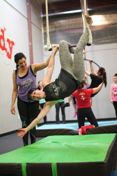 Instructor Irene Tapia coaches a trapeze student.