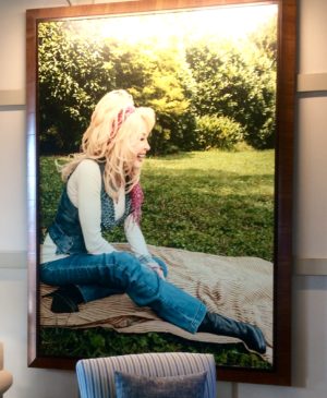 Dolly Parton’s laughing portrait hangs in the lobby of Dollywood’s Dream More Resort.