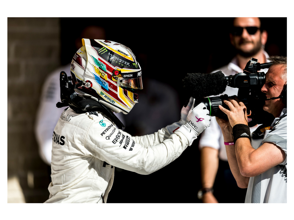 A jubilant Lewis Hamilton grabs the camera in celebration after his 5th USGP win.